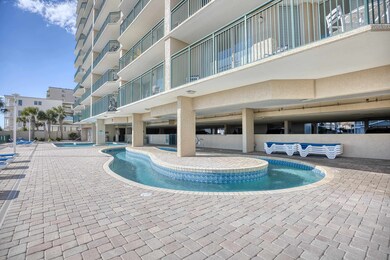 View of swimming pool featuring a hot tub
