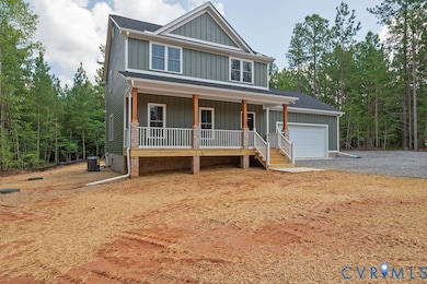 View of front of house featuring board and batten siding, a porch, and driveway