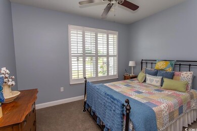 Carpeted bedroom with ceiling fan