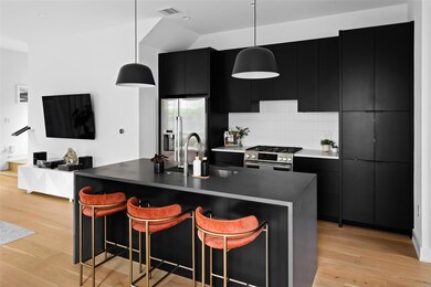 Kitchen featuring dark cabinets, appliances with 