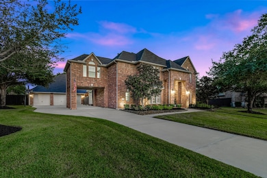 Stunning curb appeal with brick exterior and welcoming front entry at sunset.  Ample driveway and garage space - perfect for families with multiple drivers!
