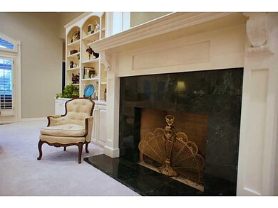 Living Room. Beautifully trimmed wood burning fireplace with marble accent.