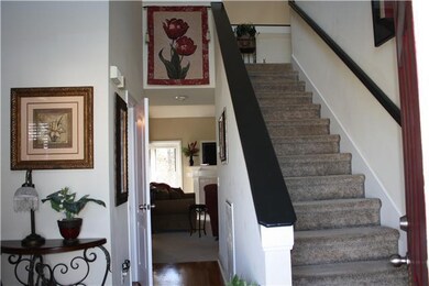 Foyer with hard woods and stairs leading to second