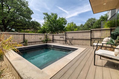 View of pool featuring a fenced backyard and a de