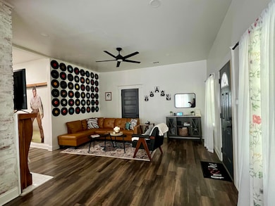 Living area with wood finished floors, a ceiling f