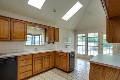Great open kitchen, tile floors, skylights, light 