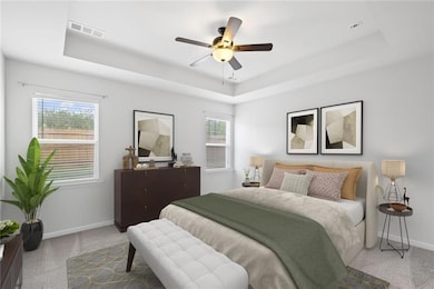 Carpeted bedroom featuring visible vents, a raised