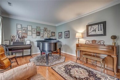 Living Room with Hardwood Floors and Crown Molding