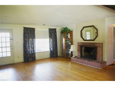 Living room has woodburning fireplace.