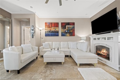Living room fireplace, a ceiling fan, and traverti