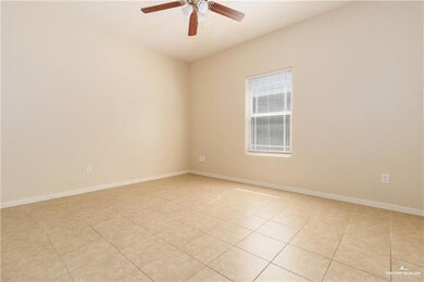 Unfurnished room with light tile patterned flooring and a ceiling fan
