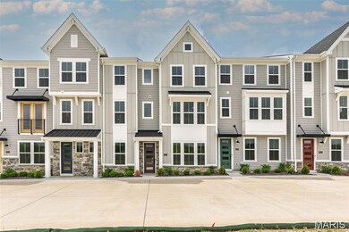 View of front of home featuring stone siding, a residential view, and board and batten siding