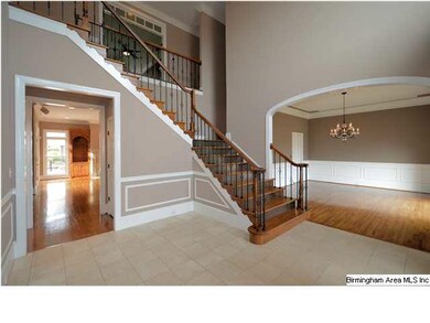 Formal dining room to right.