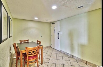Dining area with baseboards, visible vents, a text
