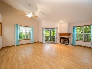 Huge living room on main level with gas log fireplace and screen doors opening on to screened in balcony.