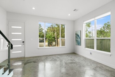 Bright, modern living area has large windows with