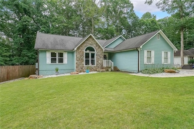 Single story home featuring a shingled roof and stone siding