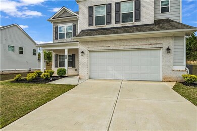 View of front facade featuring driveway, a front l