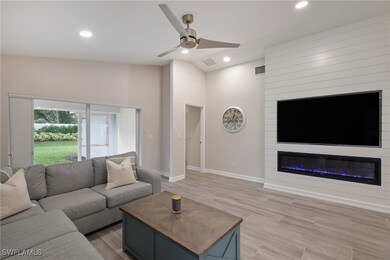 Living room featuring ceiling fan, high vaulted ce