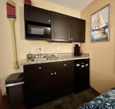 Interior space featuring a sink and black microwav