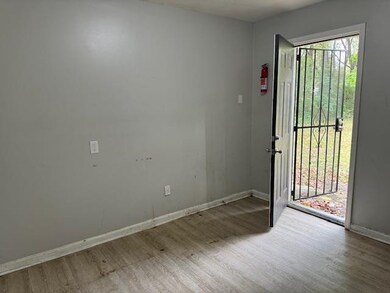 Spare room featuring wood-type flooring