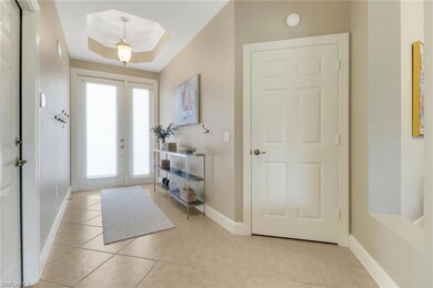 Foyer featuring baseboards and light tile patterne