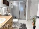 Full bathroom featuring walk in shower, toilet, an
