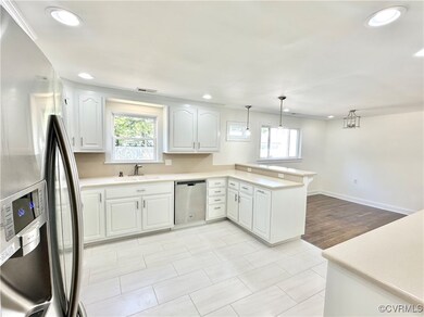 Kitchen featuring white cabinets, stainless steel