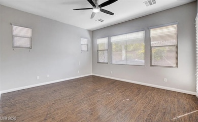 Spare room featuring dark wood-style floors, ceili