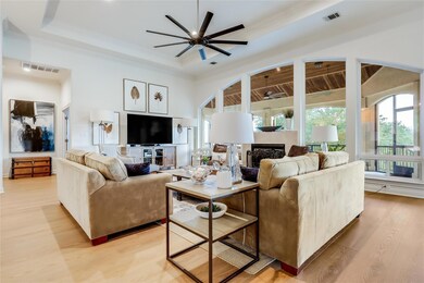 Living area with ceiling fan, light wood-style fl