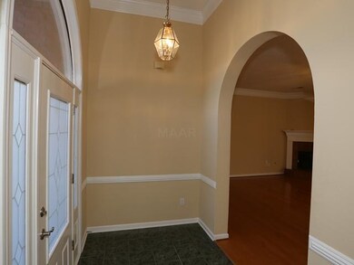 Another view of foyer showing  chair rail molding,