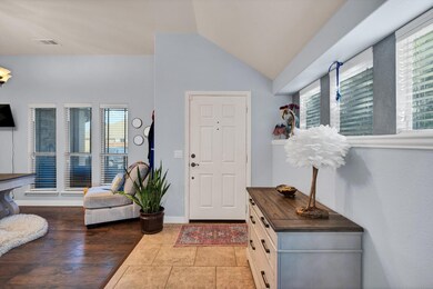 Tiled foyer entrance with vaulted ceiling and a wealth of natural light
