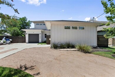 View of front of property featuring driveway, fen