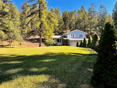 Tri-level home featuring a front yard and an attached garage