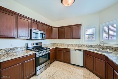 Kitchen with light stone counters, appliances with