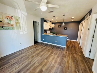 Kitchen featuring white appliances, a peninsula, 