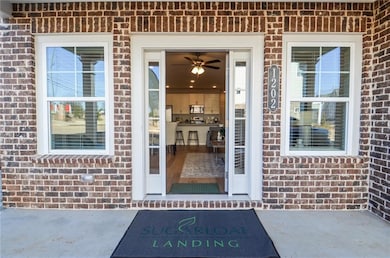 Entrance to property featuring brick siding