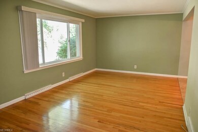 Living room with wood flooring and a picture windo