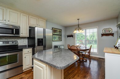 Hardwoods continue through the kitchen. Island is great for quick meal or extra prep space.