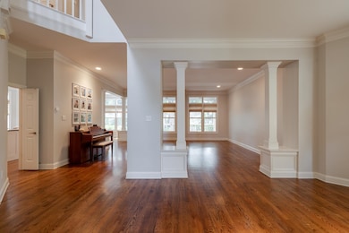 Unfurnished room featuring ornate columns, healthy