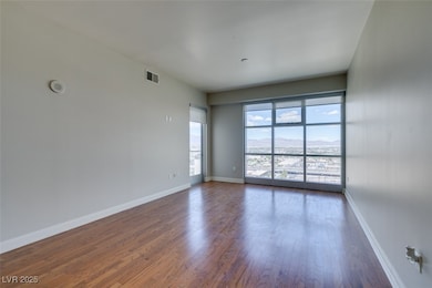 Spare room featuring dark wood finished floors and