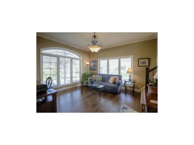 The formal dining room/sitting room offers wood fl