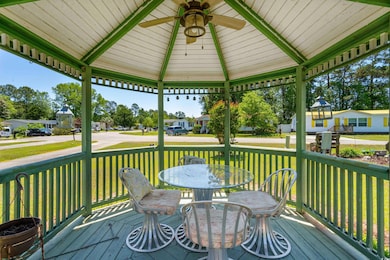 Wooden terrace with outdoor dining area, a ceiling