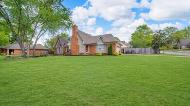 View of front of house featuring a front lawn, bri