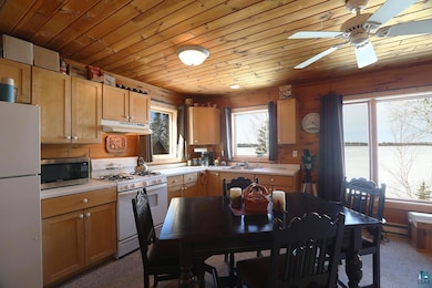 Kitchen with a sink, light countertops, white appl
