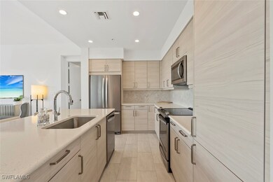 Kitchen with sink, stainless steel appliances, lig