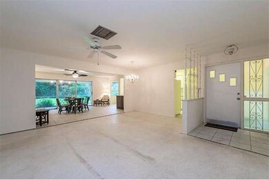 Large open floor plan with living/dining room flowing to family room. Terrazzo floors throughout.