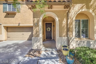 Doorway to property with stucco siding, concrete driveway, and a garage