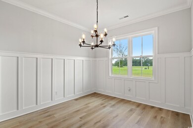 Unfurnished dining area with crown molding, an inv
