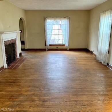 Unfurnished living room featuring a fireplace and dark hardwood / wood-style floors